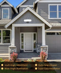 Plug In Motion Sensor Light With 3 Adjustable Heads 35W LED Outdoor Flood Light mounted on a grey house exterior under a porch.