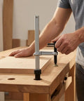 Heavy Duty Insertion Table Clamp Fixture With Ratchet Lock For Metalworking And Carpentry Benches Grab And Go Bench Hole Clamp Alloy Steel Holding Device With 160 By 80 Base And 20mm Spacing in use on a wood bench