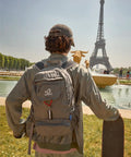 Person wearing Ultra Lightweight 20L Packable Daypack For Travel, Hiking And Camping, Foldable And Compact near Eiffel Tower