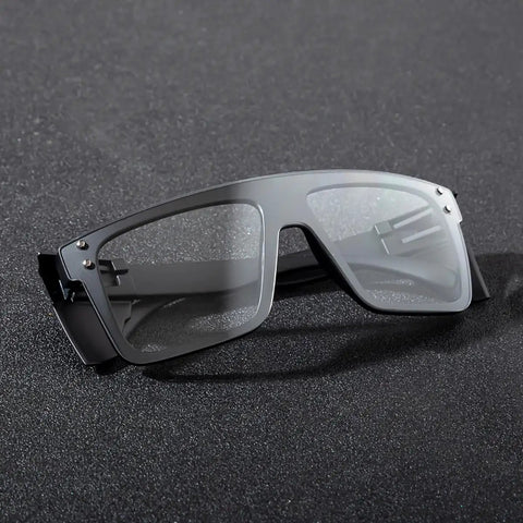 Go To Transition Photochromic Safety Glasses With UV400 Grey Lenses And Ansi Z87 Impact Resistant Wraparound Frame on a black surface.