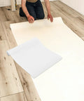 Self Adhesive Kitchen Backsplash Shield And Heat Resistant Clear Plastic Film Wrap For Cupboards being applied on floor.