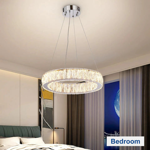 Modern bedroom with crystal chandelier, circular flush mount design, farmhouse style black globe pendant light with adjustable chain.