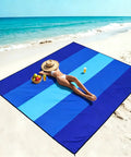 Woman relaxing on Mega Waterproof And Sandproof 10 By 9 Ft Mat For 2 To 8 People Quick Dry Outdoor Picnic Sheet at the beach