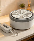 Portable USB Mini Washing Machine With Dead Simple Deep Clean Stain Removal Compact Travel Clothes Washer on a countertop.