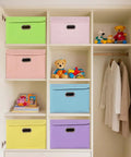 Premium Pink Fabric Storage Cubes Featuring Reinforced Stainless Steel Handles And Secure Cover Lids For Killer Closet Setup And Super Collapsible Foldable Nursery Bins To Organize Your Space Like A Pro stored in a closet with colorful bins.