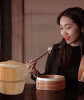 Kickin Flavor Infusion Starts With This Handmade Wooden Rice Steamer Bucket And Tight Fitting Lid on a table with heat safe handles.