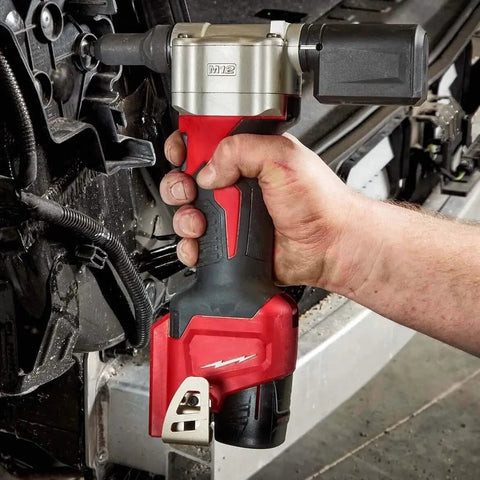 Beefy Cordless Rivet Tool For 12 Volt Power Batteries used for fastening, held in hand, compact design ideal for work.