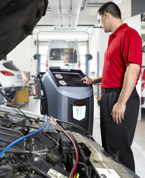 Pro Grade Full Auto R134a Shop Ready Car AC Refrigerant Recycling Recovery Recharging Unit in use by a mechanic in shop.