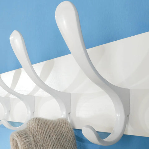 Close-up of white hooks on Wooden Wall Coat Rack With Six Hooks White Finish Modern Space Saving Wall Hanger for coats and clothes