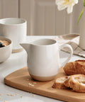 13oz Creamer With Handle Ceramic Pitcher For Coffee, Milk, Syrup And Sauce, Multipurpose Stoneware Jug, White on a table setting
