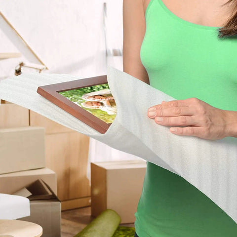 Hella Durable White Epe Pearl Cotton Pouches 100 Pack Kickass Bubble Wrap Alternative For Moving Shipping, a woman using a pouch to protect a picture frame.