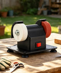 Portable Mini Bench Grinder With Dual Fine And Coarse Grinding Wheels For Woodworking Sanding Tool Edge Sharpening Burr Removal Compact Desktop Electric Grinder on wooden table.