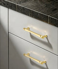 Top Tier Solid Zinc Alloy Cabinet Pulls 10 Pack Slick Brushed Gold Heavy Duty Drawer Handles For Modern Kitchen Upgrades And Bathroom Vanity Reno With Exactly 5 Inch Mounting Centers on white cabinets.