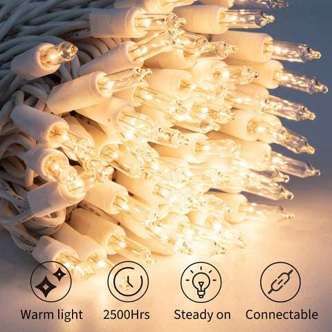 Warm White 50 Count Mini Christmas Lights On White Wire coiled showing warm glow and clear incandescent bulbs