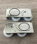 Heavy Duty Double Wheel Sliding Door Track Rollers With Rugged Aluminum Frame And Silent Nylon Wheels For Slick Action Windows And Smooth Room Panels Quick Swap Replacement Parts No Sweat Install, close-up of aluminum track rollers with engraved markings.