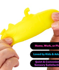 Fingers holding a yellow NeeDoh sensory squishy for stress relief in the Squishmas Advent Calendar with 24 Days Of Hype.