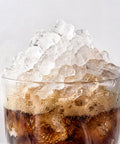 Glass of cola topped with chewable pebble ice from Nugget Ice Maker For Countertop With 44 Lb Per Day Capacity Self Cleaning Black Stainless Steel Portable Ice Machine Delivers Cafe Style Soft Chewable Pebble Ice For Home Kitchen RV And Office