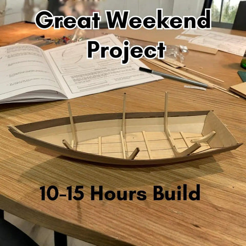 Wooden Model Boat Building Kit For Beginners, All In One Starter Set With Tools Glue And Paint, 1 To 12 Scale Dinghy on table.