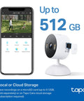 2K Indoor Outdoor Wired Security Camera Kit For Dope Home Surveillance With Baby Monitor And Pet Cam Person And Motion Detection Baby Cry Alerts 2 Way Audio Siren Local SD Storage Or Optional Cloud 2 Pack next to a smartphone showing surveillance footage.