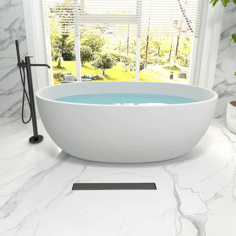 24 Inch Linear Shower Drain Tile in Grate Matte Black Floor Drain Kit No Flange seen with a white oval freestanding bathtub.
