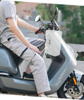 Tough As Nails Weatherproof Socket Box For E Bike Charger Shield mounted on scooter for outdoor use, durable white plastic housing.