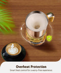 Overhead view of Detachable Milk Frother With Four Temperature Settings Delivers Barista Style Foam For Hot Or Cold Drinks Five In One Frothing And Heating Options Dishwasher Safe 400ml Perfect For Latte Cappuccino Hot Chocolate with a frothed drink on a wooden table.