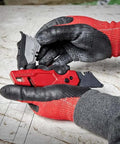 Hands holding Compatible With Milwaukee Fastback Utility Knife Model 48 22 1502, red handle, folding box cutter, blade storage.