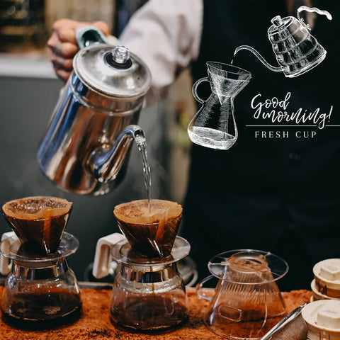 Front view: two glass pour-over coffee carafes with cone filters and a metal kettle pouring hot water
