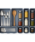 8 Piece Interlocking Drawer Organizer Trays Set In Light Gray Plastic with utensils and spices in kitchen drawer