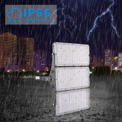 Killer Brightness 300W LED Work Lights Outdoor Flood Light Fixture IP66 Waterproof in rain against city skyline at night.