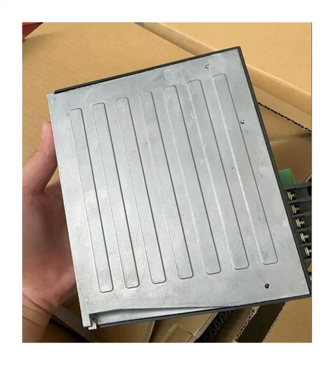 Person holding BLED6C Motor Controller Industrial Motion Drive for Automation Equipment. Metal casing and connectors visible.