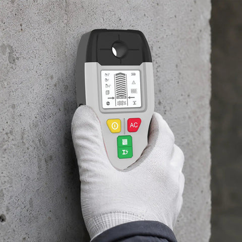 6-in-1 Stud Finder Wall Scanner Metal Detector LCD Display(Grey) held in hand against a concrete wall, showing bright LCD interface.