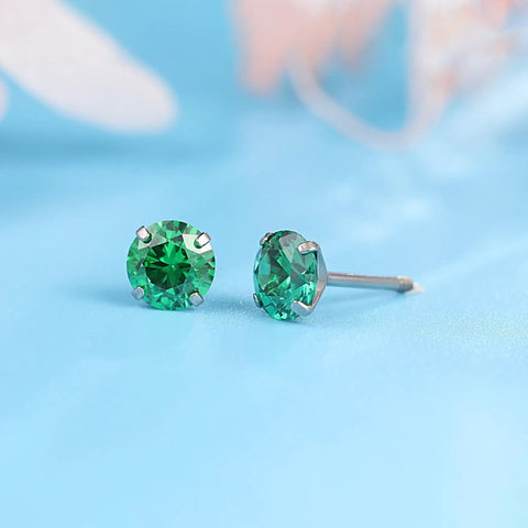 Close-up of Snag Dope G23 Implant Grade Titanium Screw Back Earrings with green cubic zirconia for sensitive skin.