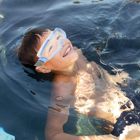 Heavy Duty Polycarbonate Safety Glasses With High Clarity Blue Lens Side Shields For Industrial Construction And Lab Work Built Tough For The Daily Grind And Straight Up Eye Protection worn by a child in a pool.