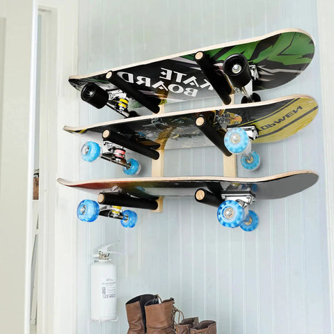 Handcrafted Natural Wood Wall Mount Skateboard Rack Holds Three Longboards And Snowboards Featuring Protective Cushioned Sleeves, displaying three skateboards mounted on the wall.