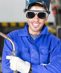 Heavy Duty Welding Safety Glasses And Protective Goggles 10 Pack Featuring Auto Darkening Lenses worn by smiling worker in blue overalls.
