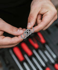 Person holding M10 Wedge Locking Washers Heavy Duty Manganese Steel Anti Vibration Safety Lock Hardware For Screws And Bolts Fastener Pack.