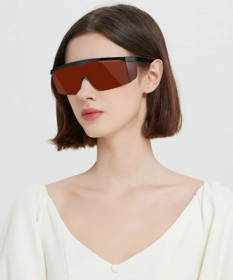 Built Tough Laser Safety Glasses Bringing Game Changing Od Five Plus Coverage From One Ninety To Five Fifty Nanometers And Eight Hundred To Eleven Hundred Nanometers Anti Fog Goggle For Ipl Laser Hair Removal Crews worn by a model with tinted red lenses.