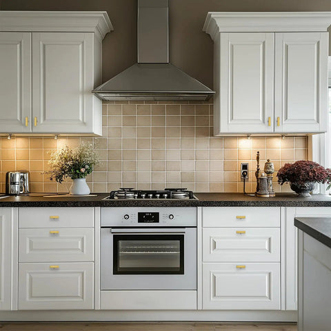 Thirty Hella Sturdy Brushed Brass Cabinet Knobs Featuring Slick Two Inch Square Bar Hardware installed on white kitchen cabinets.