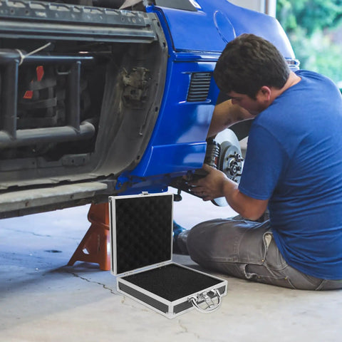 Premium Aluminum Tool Box Featuring Heavy Duty Build And Secure Snap Lock Cover For Van Life Adventures Job Site Projects Weekend Warrior Gear Compact Alloy Storage Case open next to a mechanic working on a car.