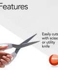 Hand using scissors to cut Premium Clear Floor Protector Mat 27 Inch By 12 Foot Waterproof Roll for easy customization.