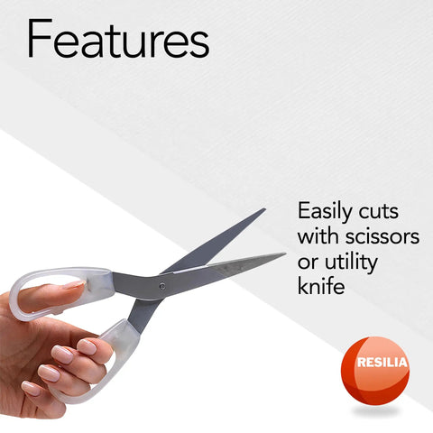 Hand using scissors to cut Premium Clear Floor Protector Mat 27 Inch By 12 Foot Waterproof Roll for easy customization.
