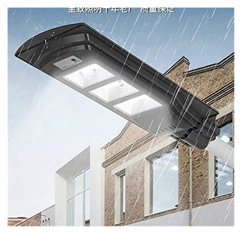 Badass 350W Solar Floodlight With Radar Human Body Induction Dusk To Dawn IP67 Waterproof LED Outdoor Security Light in rain above building.