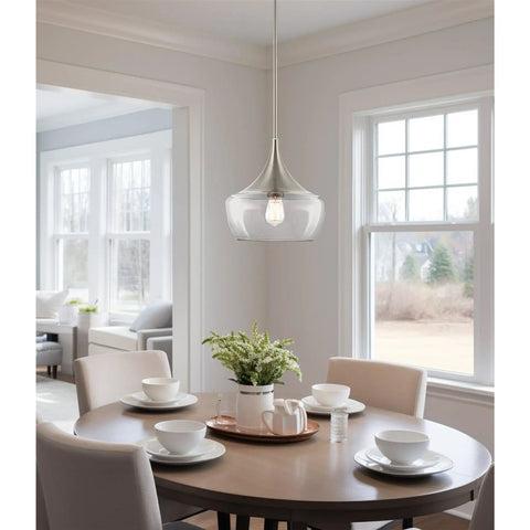 13 Inch Modern Pendant Light With Clear Schoolhouse Glass Shade In Brushed Nickel Finish hanging over dining table with chairs