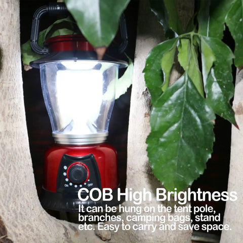 Battery Powered LED Lantern With Variable Power For Camping Dimmable COB LED Light hung in tree, red, outdoors