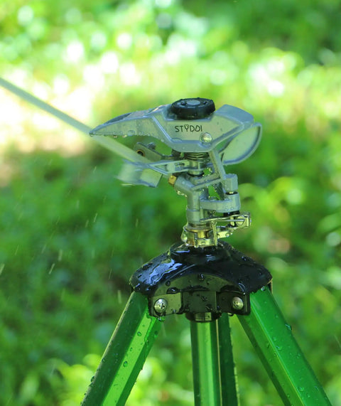 Heavy Duty Metal Impulse Sprinkler Head With Half Inch NPT Thread, Pulsating Sprinkler For Lawn, Yard, And Garden shown on tripod