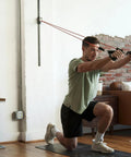 Top Tier Space Saving Home Gym Resistance Band System With Gliding Wall Track Three Foot Aluminum Mount And Five Bands Plus Handles in use.