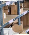 Heavy Duty PVC Wire Shelf Label Holders 30 Pack Clear Display Fronts on shelves organizing cardboard boxes.