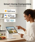 Person using a smart home tablet in a kitchen, compatible with Apple Home, Google Assistant, and Alexa for device integration.