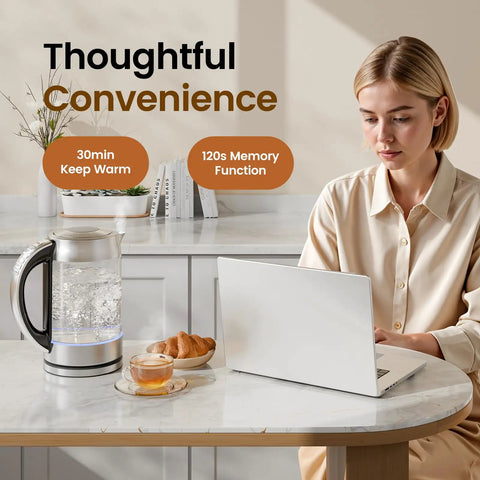 Woman using laptop beside 1.7L Glass Electric Kettle for Coffee and Tea With 6 Temperature Presets, Rapid 1500W Boil, Keep Warm Memory.